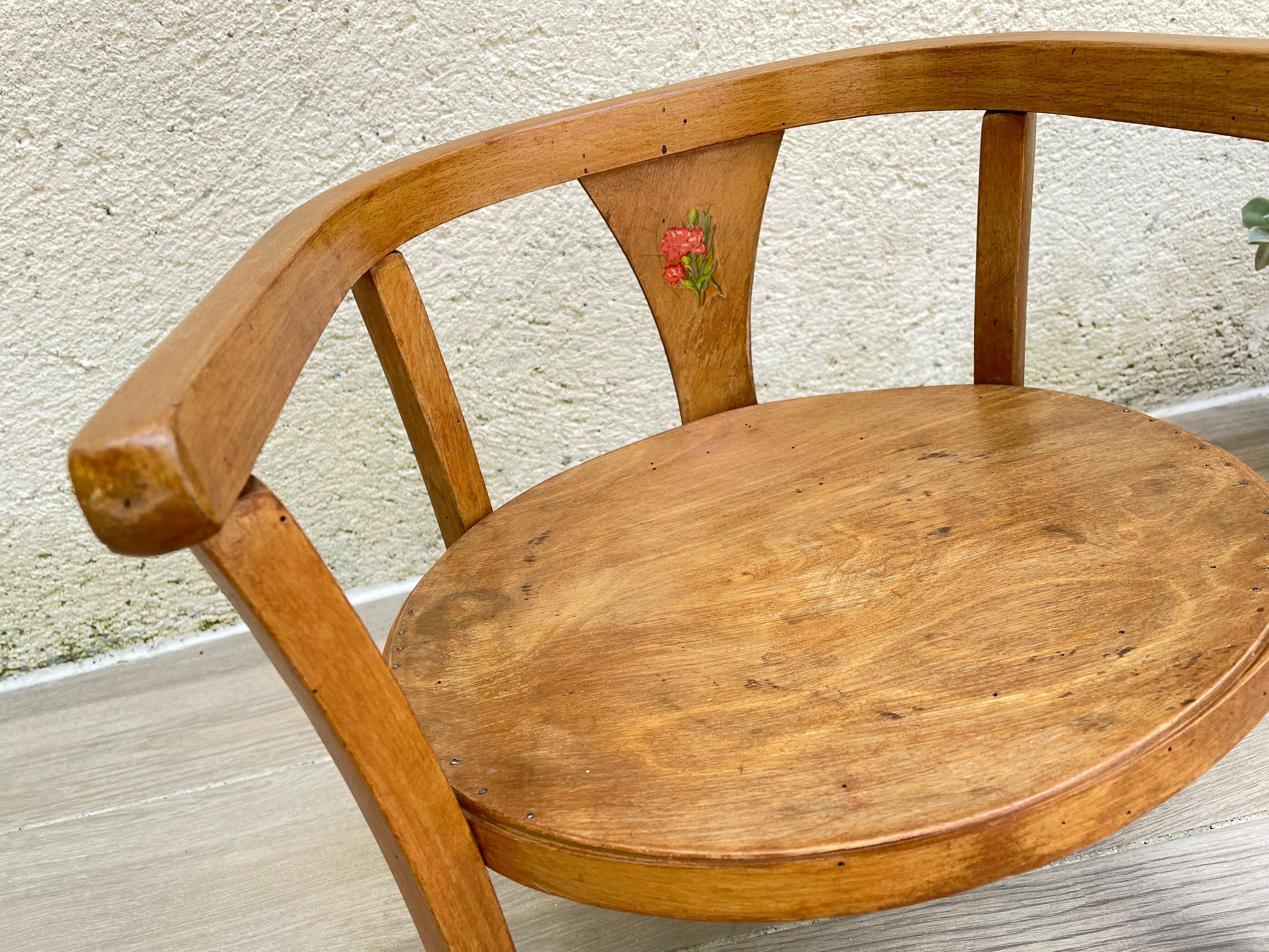 Old armchair for children in wood