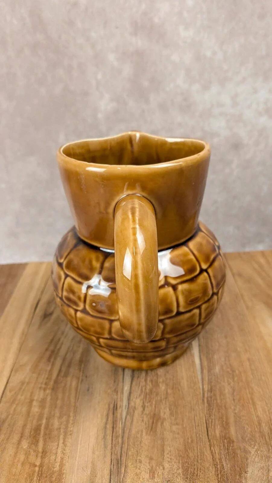 Vintage Sarreguemines pitcher with brown relief decoration.