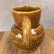 Vintage Sarreguemines pitcher with brown relief decoration.