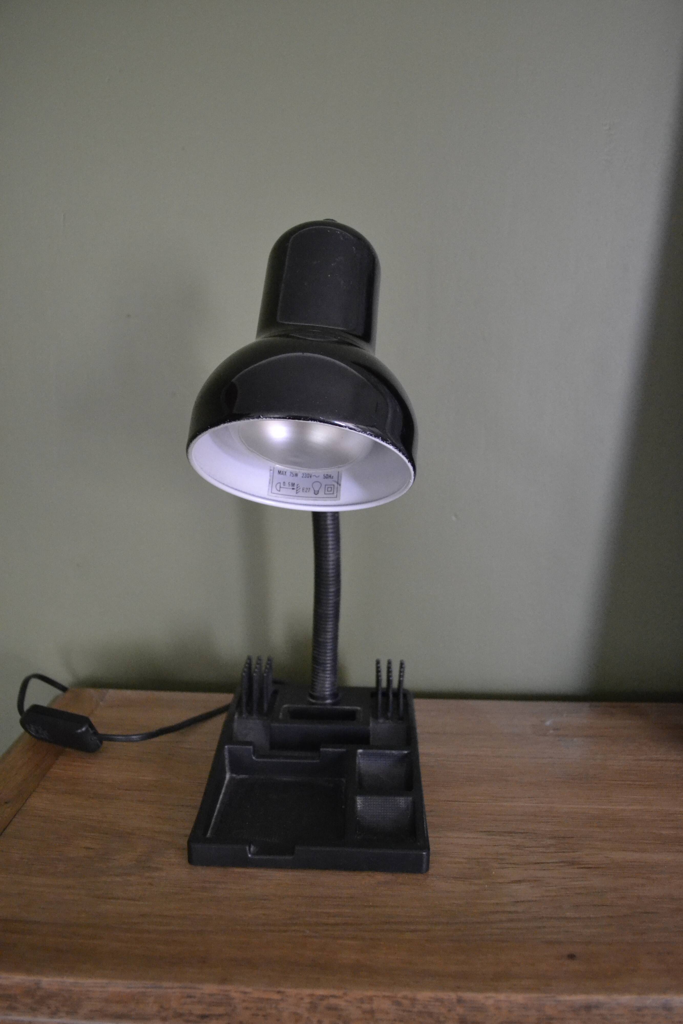 Black flexible desk lamp with built-in flashheld