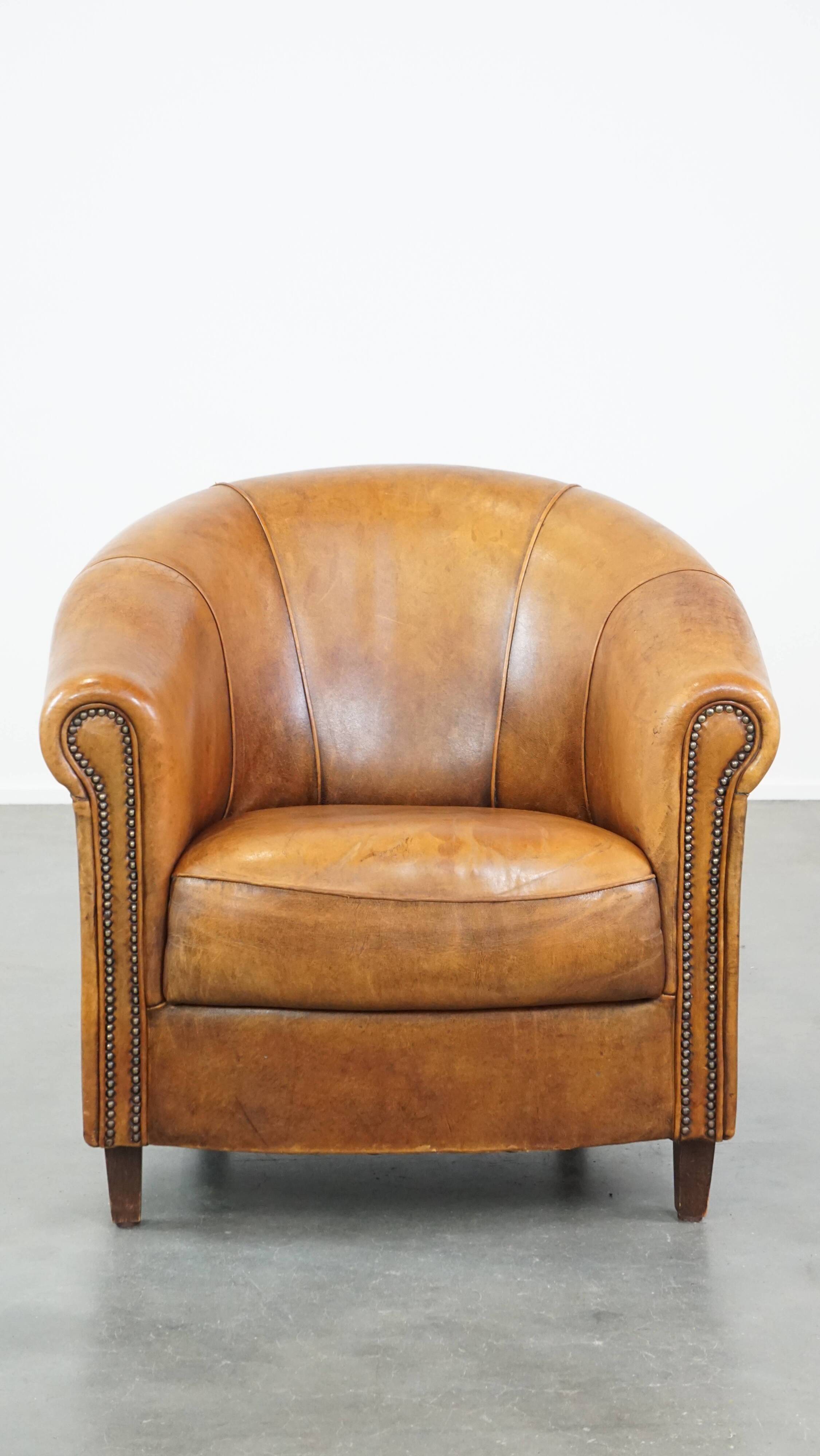 Cognac-colored sheep leather club chair with patina