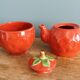 Teapot and cup in the shape of a strawberry.