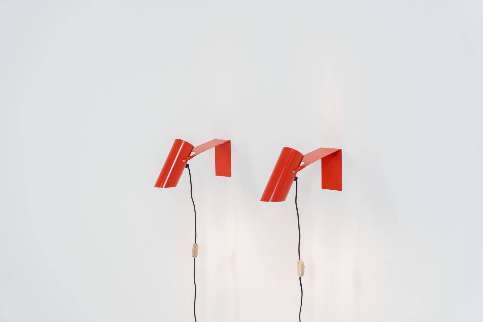 Pair of red metal wall lights