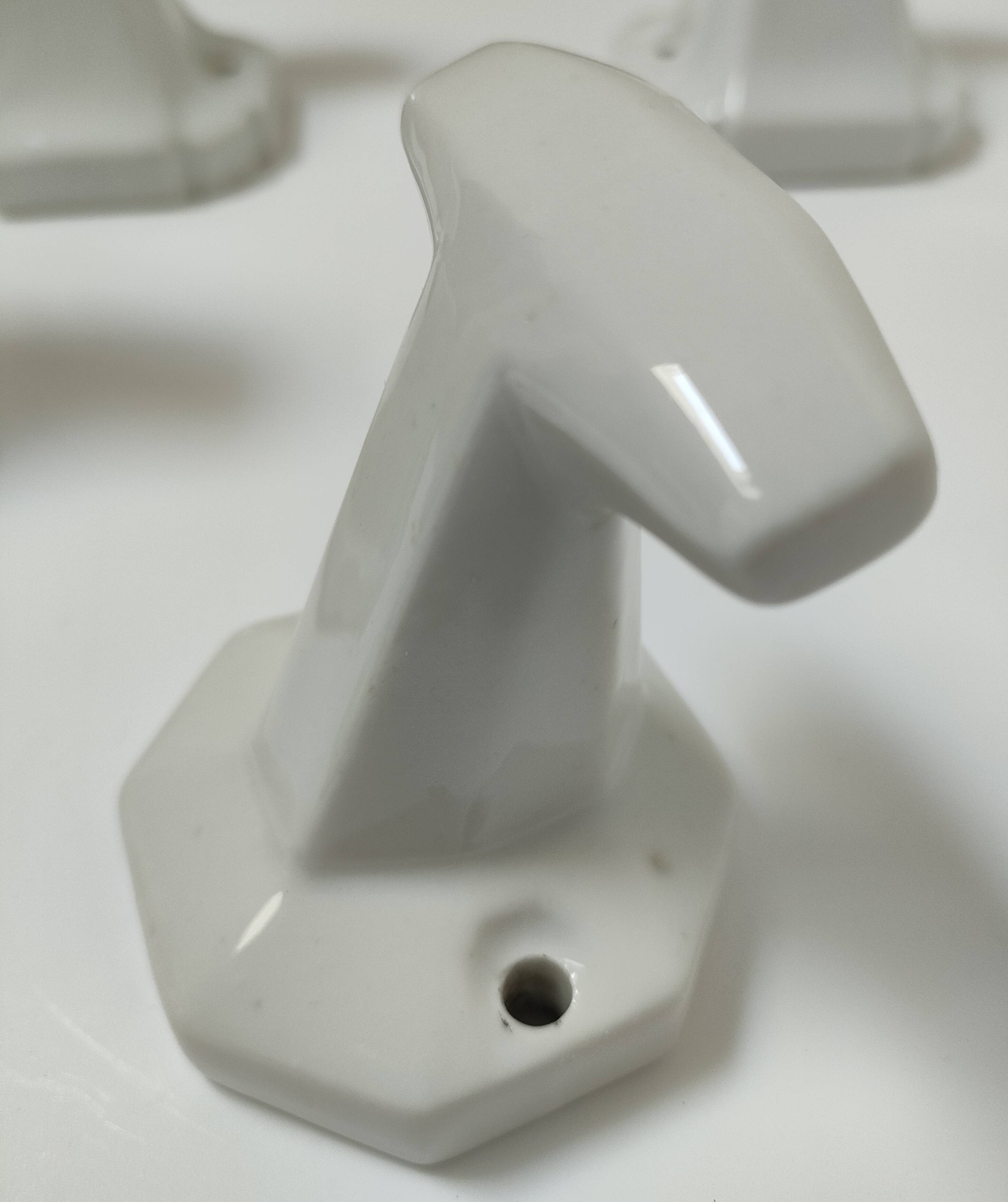 Five art deco white porcelain hooks