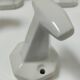 Five art deco white porcelain hooks