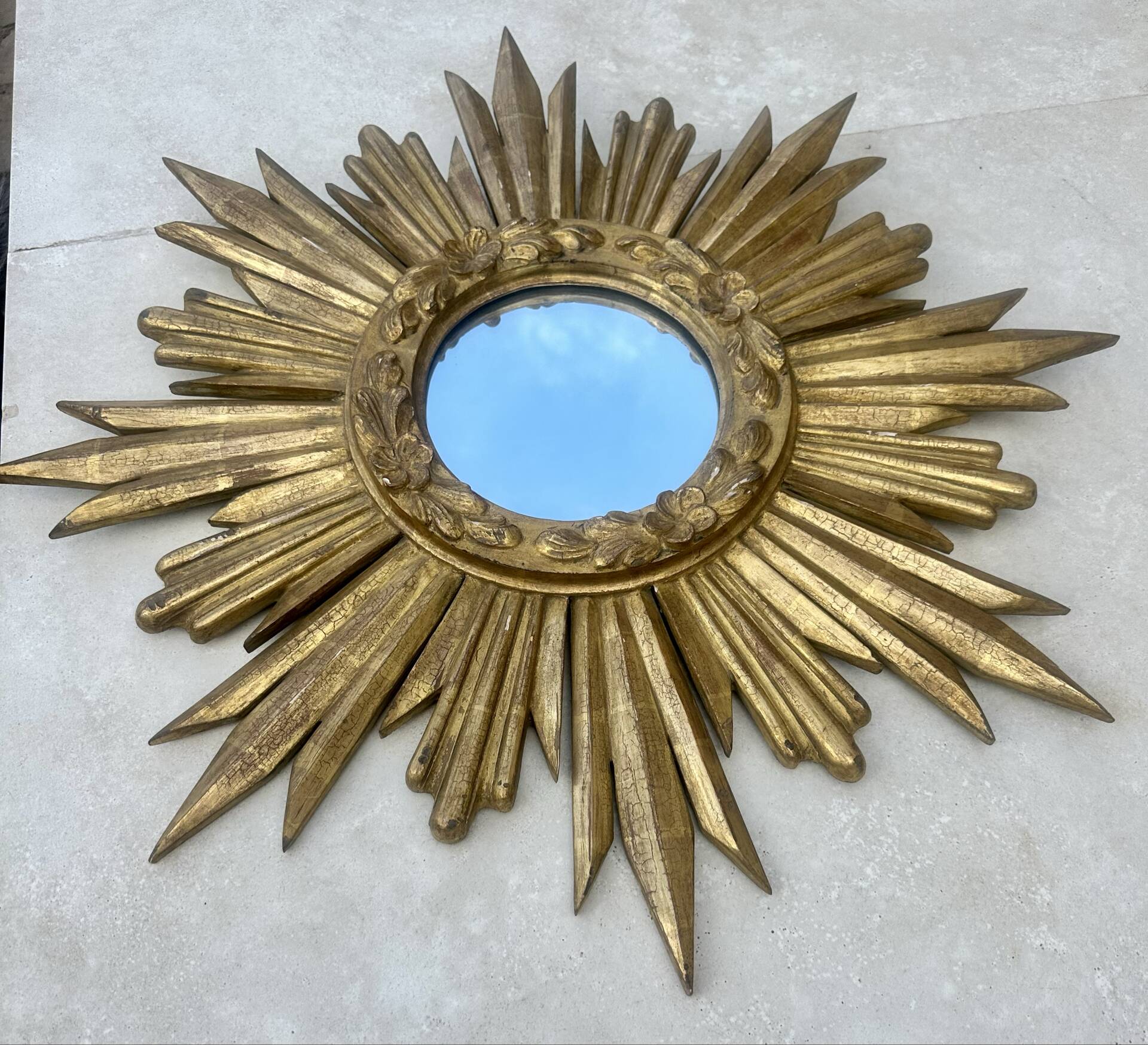 Large sun mirror in carved gilded wood.