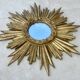 Large sun mirror in carved gilded wood.