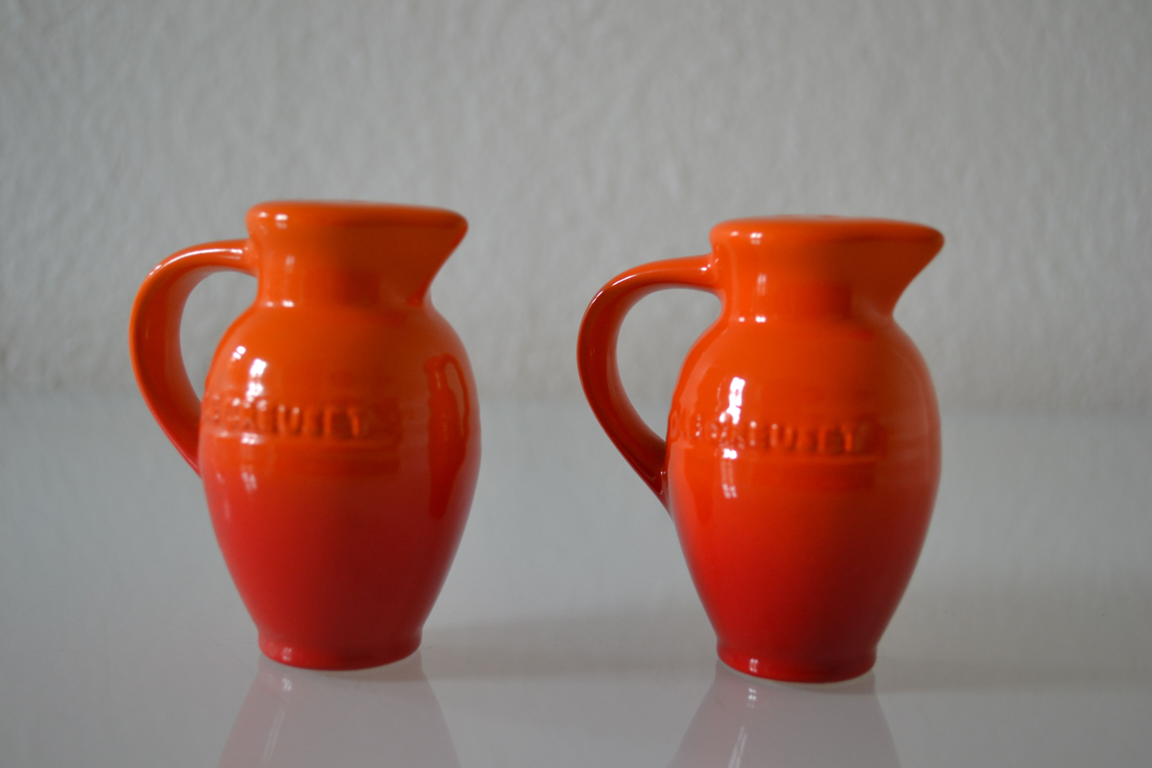 Le Creuset orange advertising salt and pepper