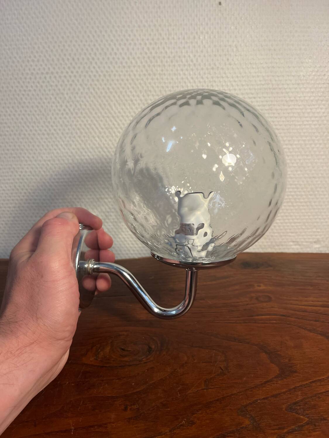 Delmas chrome wall light with chiseled glass globe