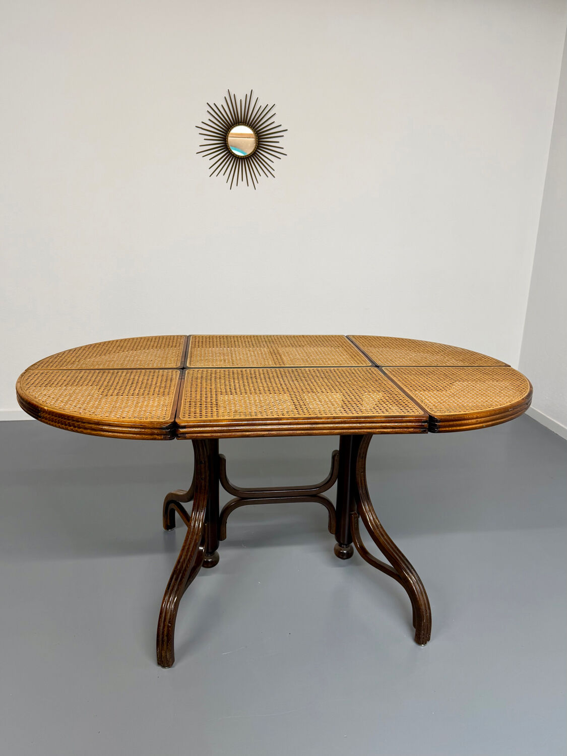 Vintage dining table with a cane top by Mundus from the 1970s.