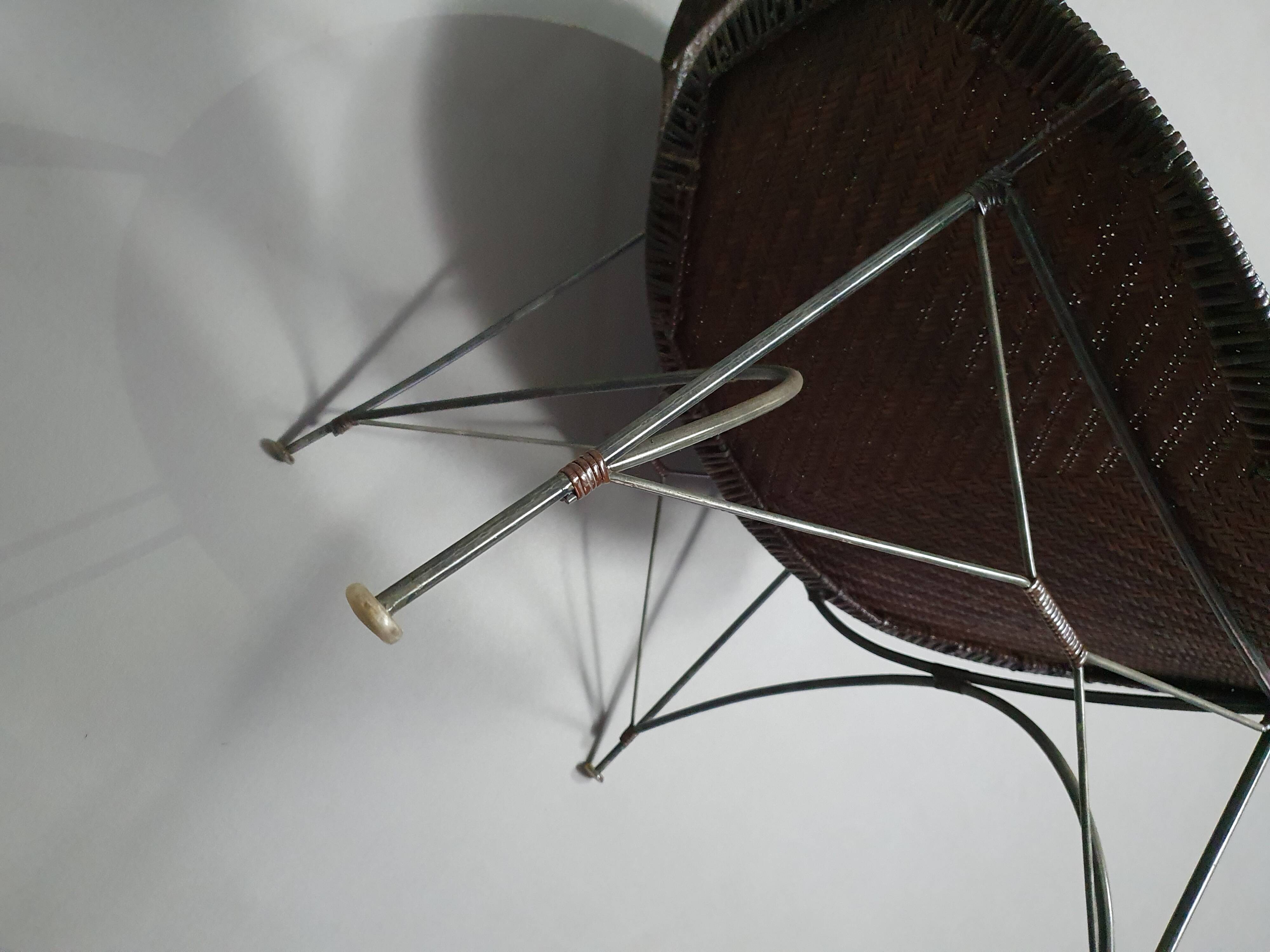 Armchair designed by Yuzuru Yamakawa  Metal frame.  Seat and back in braided rattan.