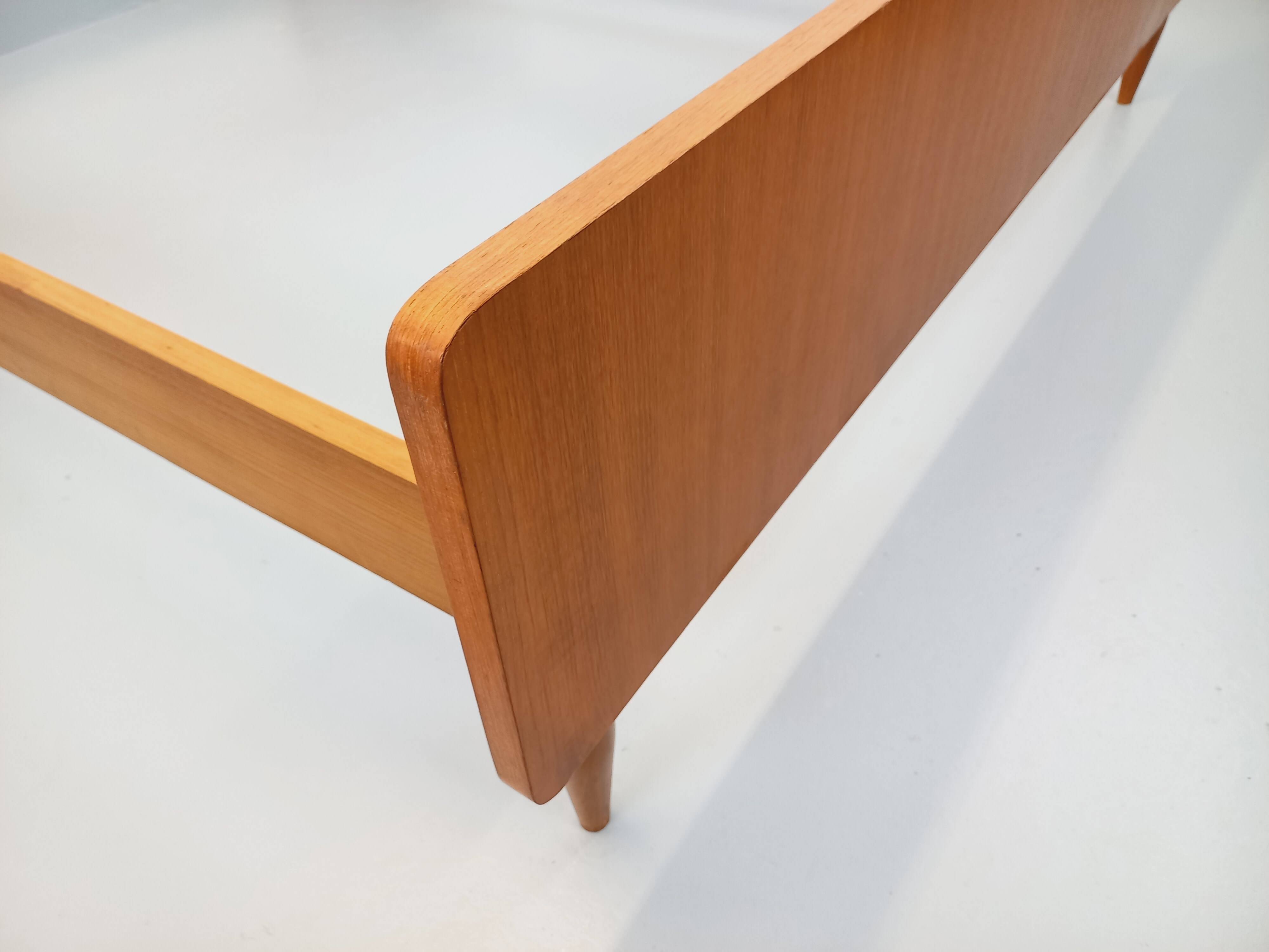 Double bed in vintage Scandinavian style from the 1960s with bedside tables.