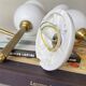Pair of torch wall lights in brass, white glass and porcelain.
