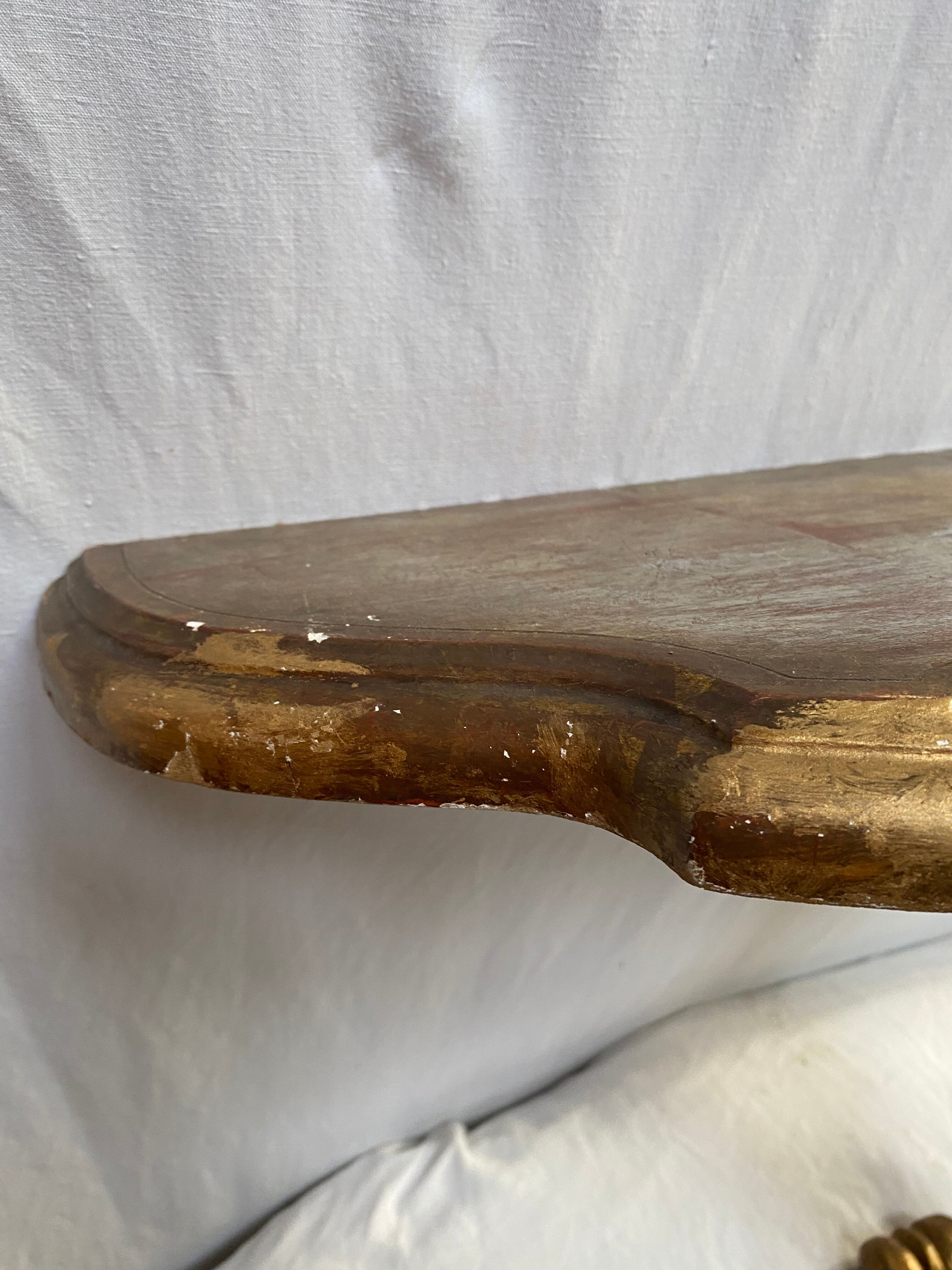 Wooden wall console and antique gilded stucco