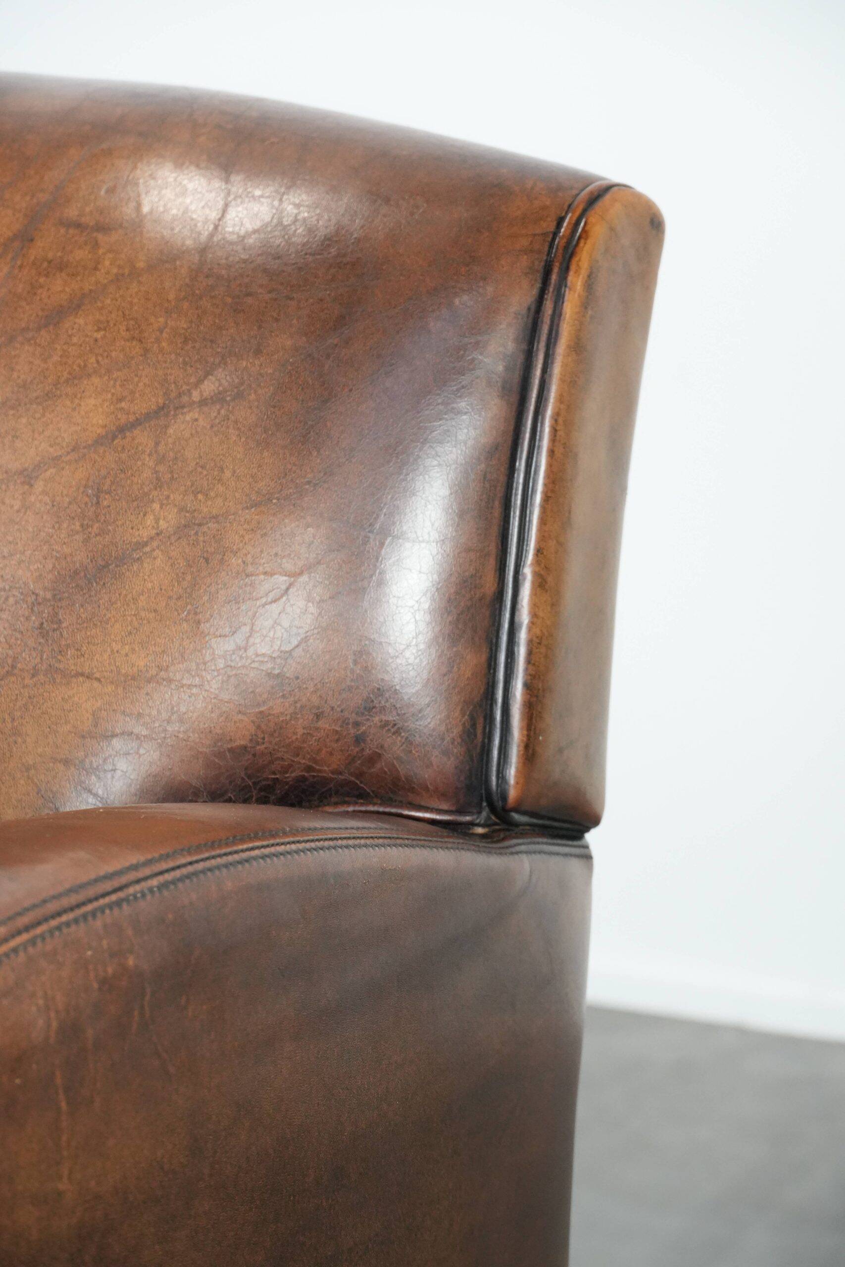 Characterful vintage sheepskin leather armchair with beautiful colours