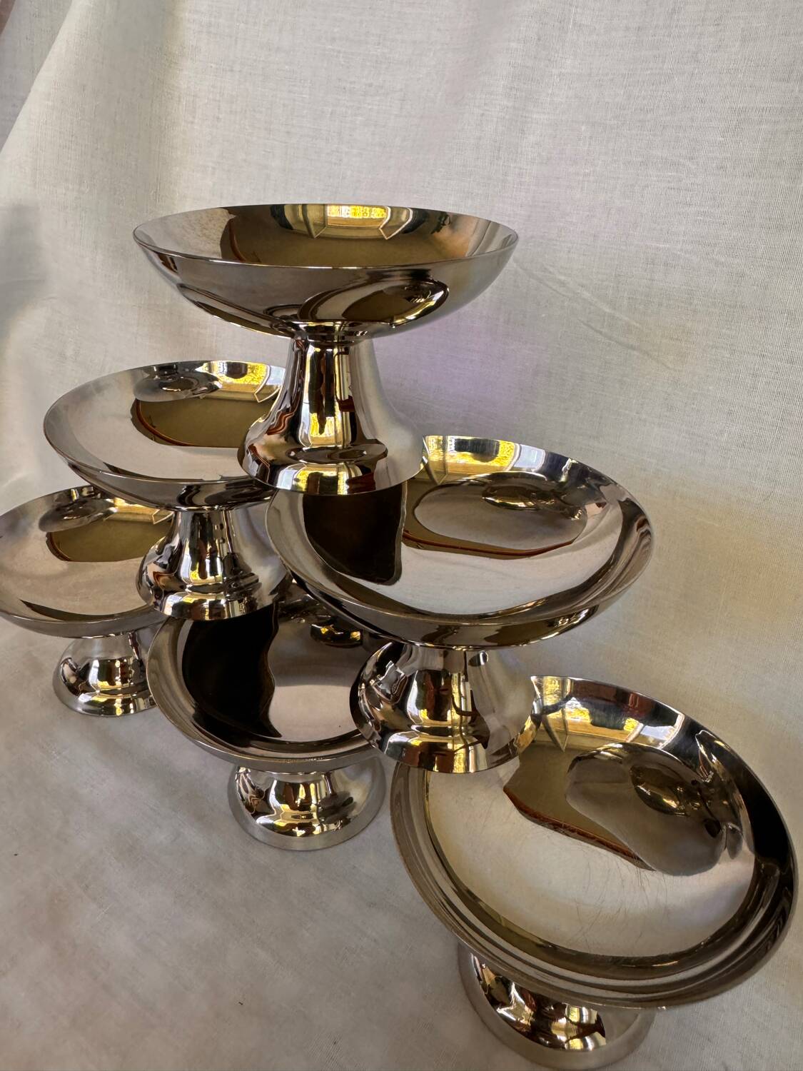 Set of 6 stainless steel ice cream bowls by Guy Degrenne with matching spoons.
