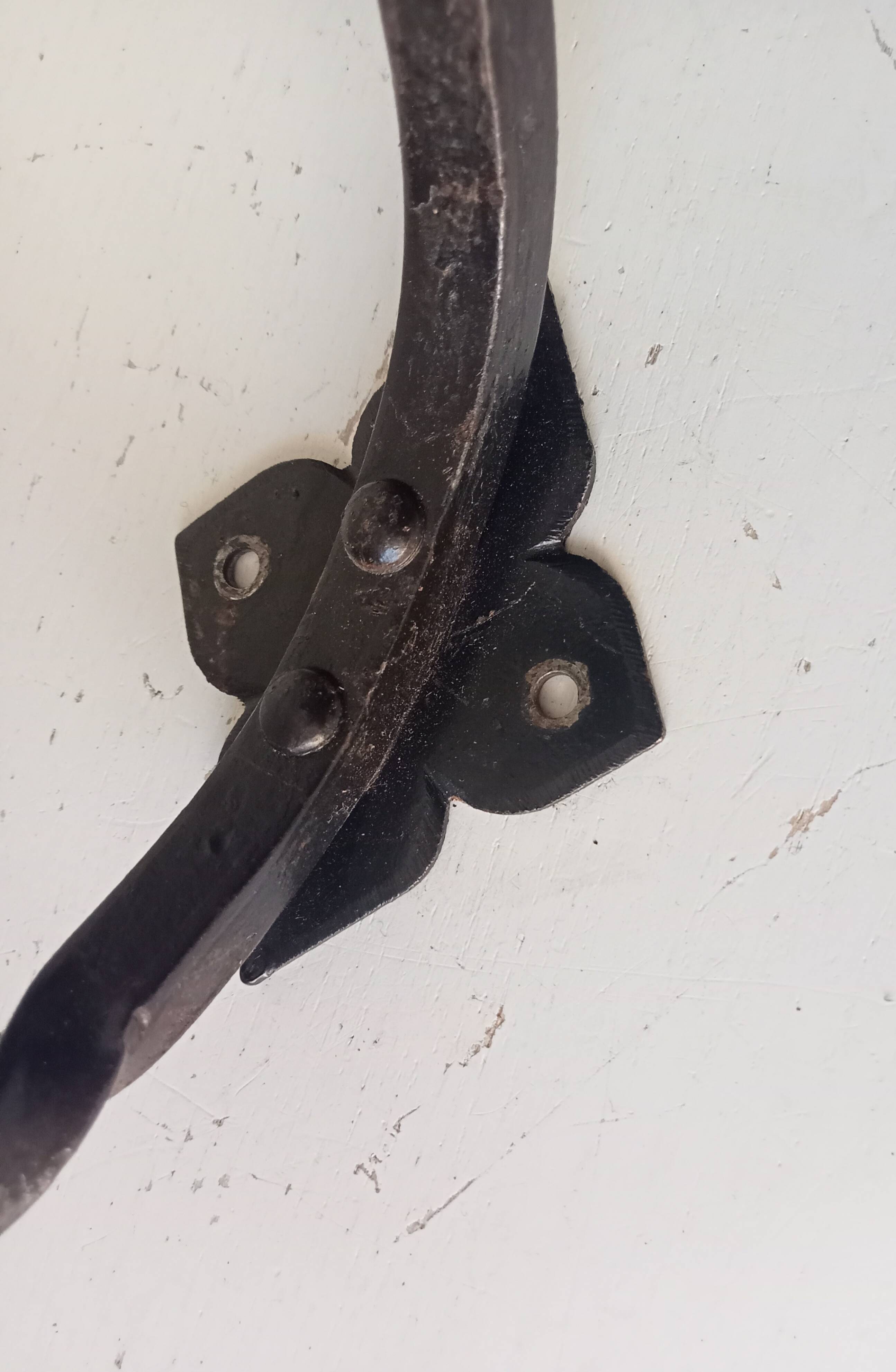 Brutalist wall coat rack in wrought iron.
