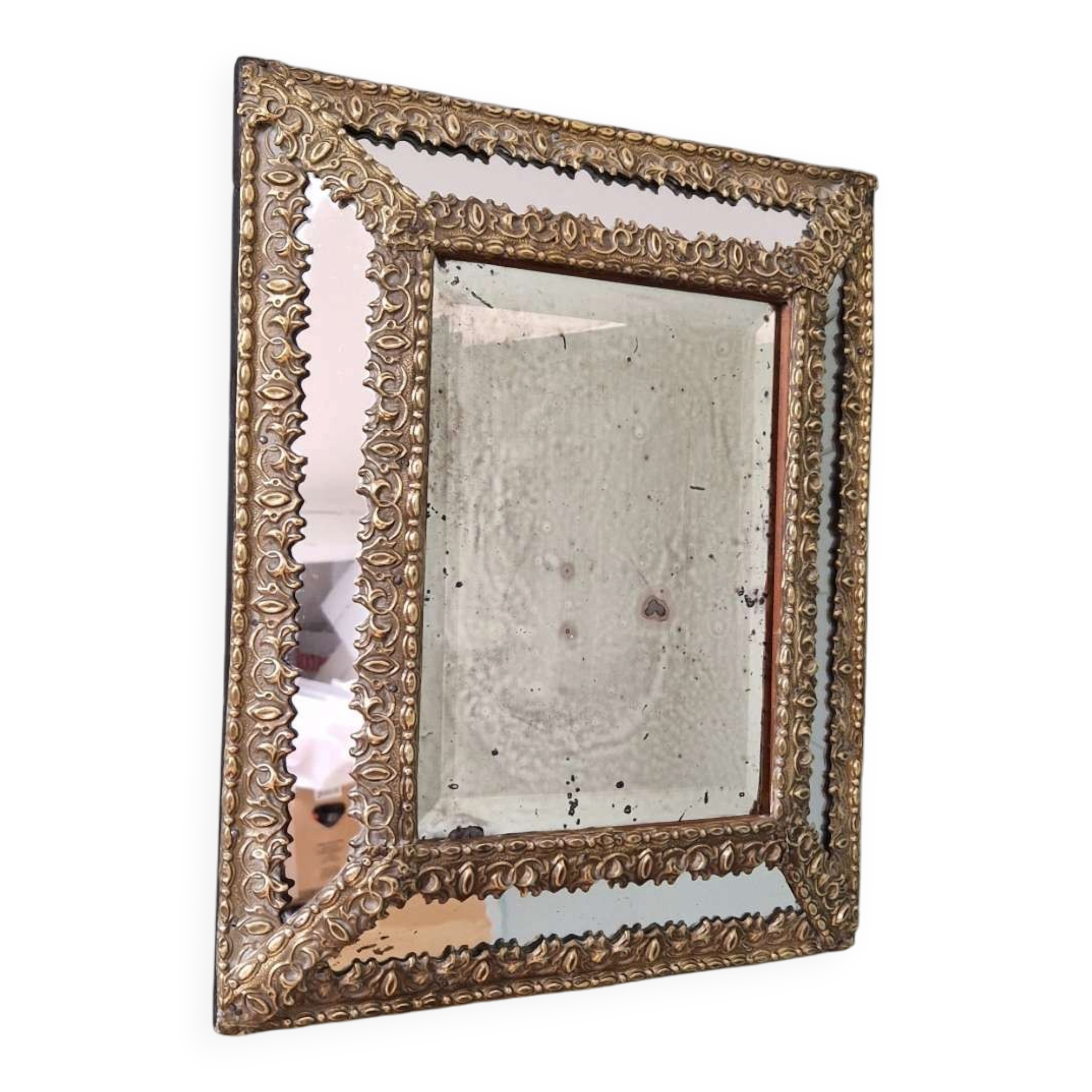 Mirror with repoussé brass frame, mercury glass, 19th century.