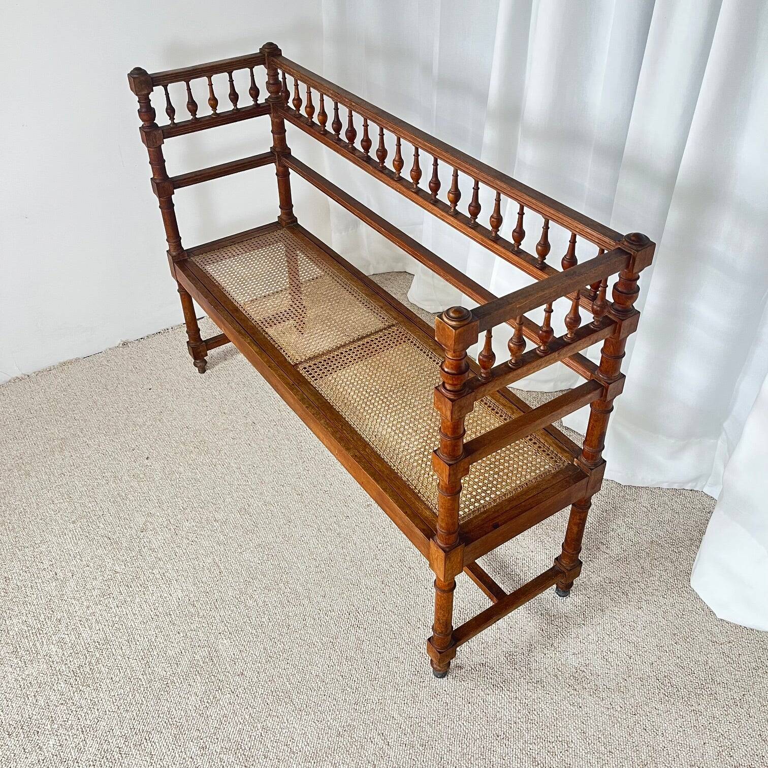 Antique banquette in Louis XIII style, turned wood with caning, late 19th to early 20th century.