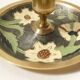 Set of 2 round golden metal candle holders and floral patterns