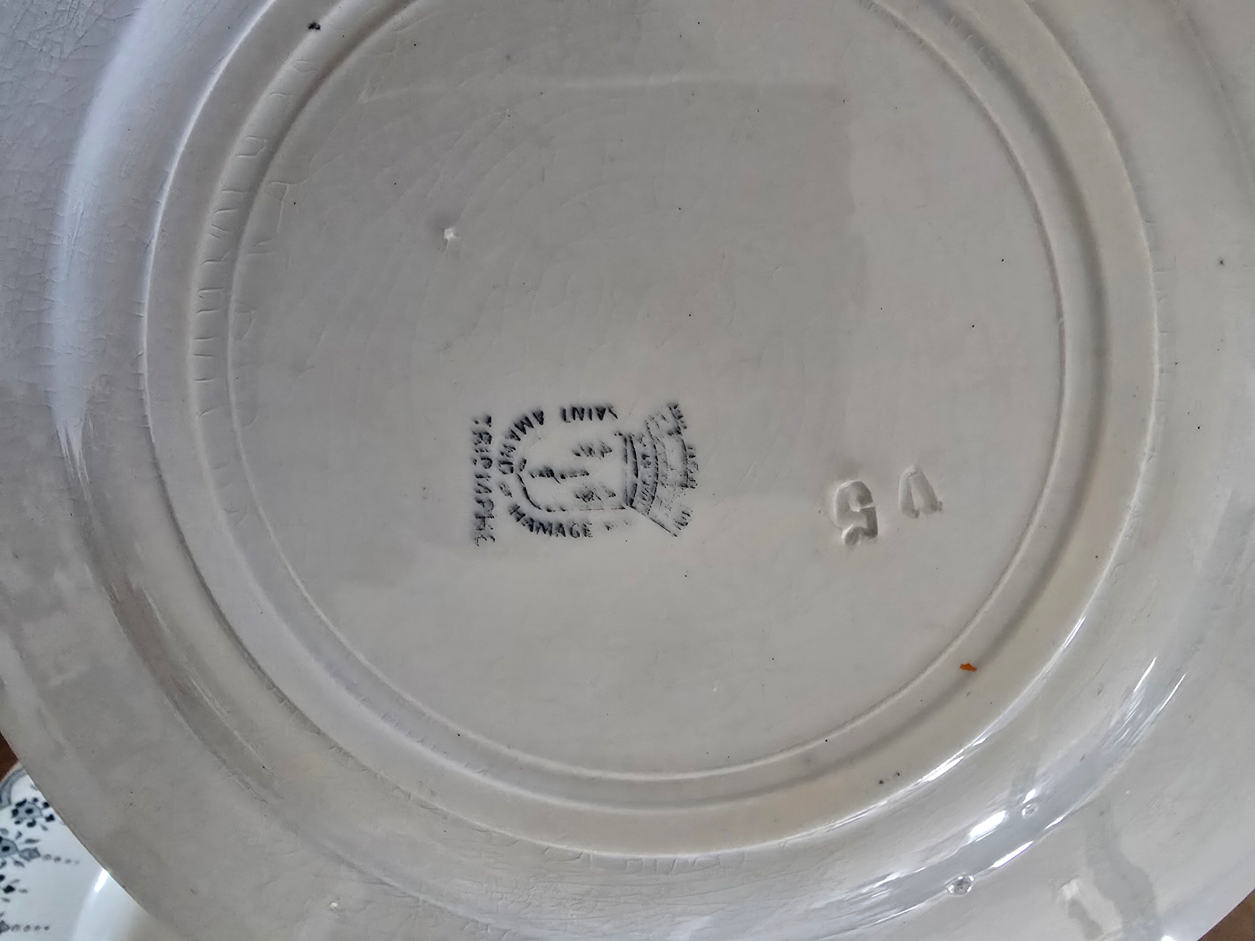 Old green-blue faience plates and dishes with geometric patterns.