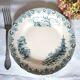 Mismatched antique flat plates made of ironstone pottery.