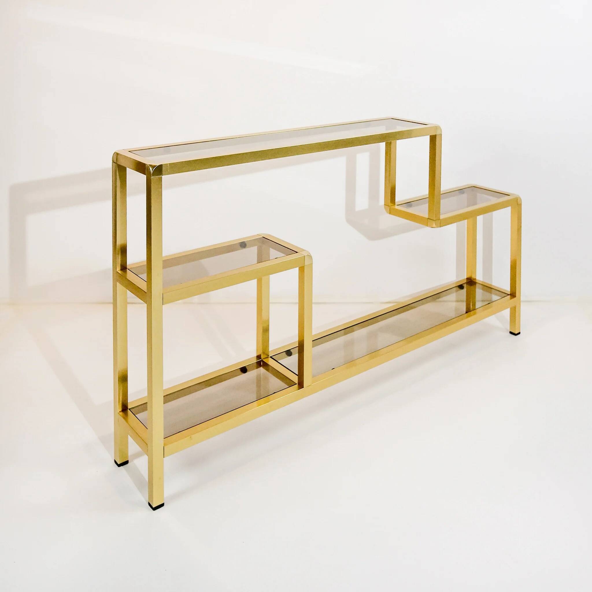 Vintage shelves in brass and smoked glass.