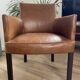 Chair with armrests in aged brown cowhide leather