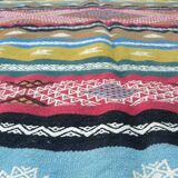 Traditional Berber tribal kilim rug with multicoloured geometric patterns.
