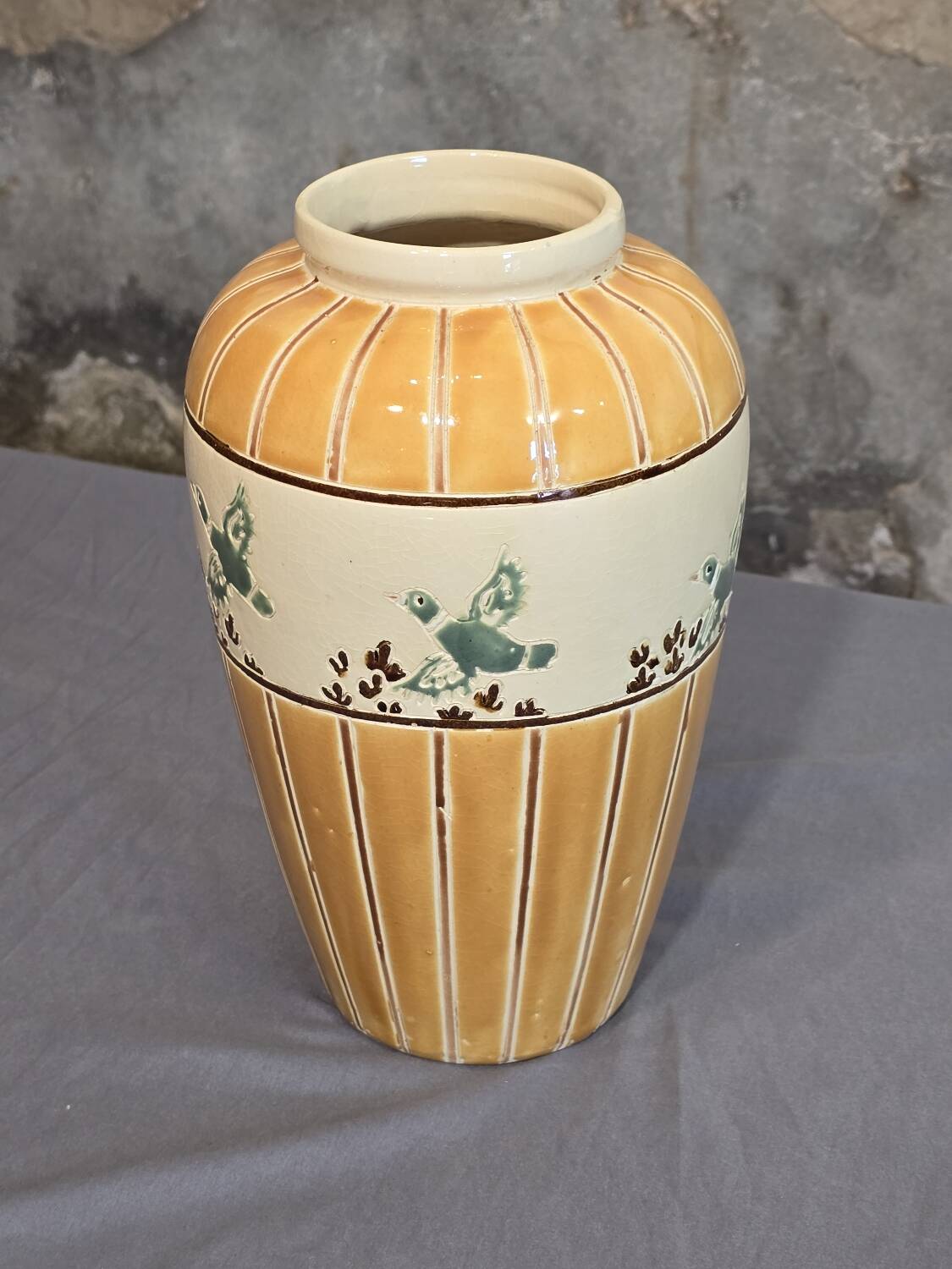 Orange and green ceramic vase with duck motif