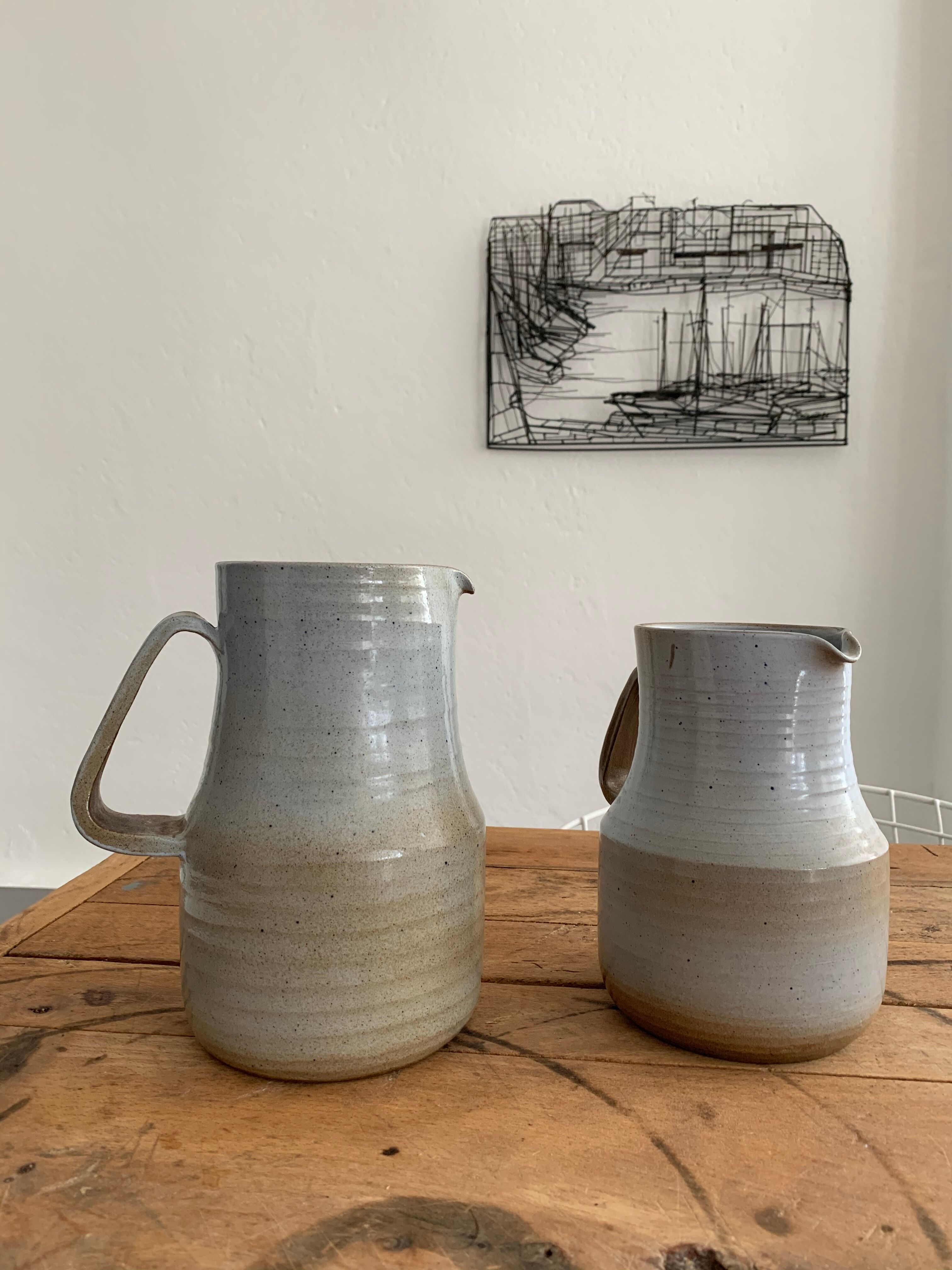 Pair vintage enamelled ceramic pitchers