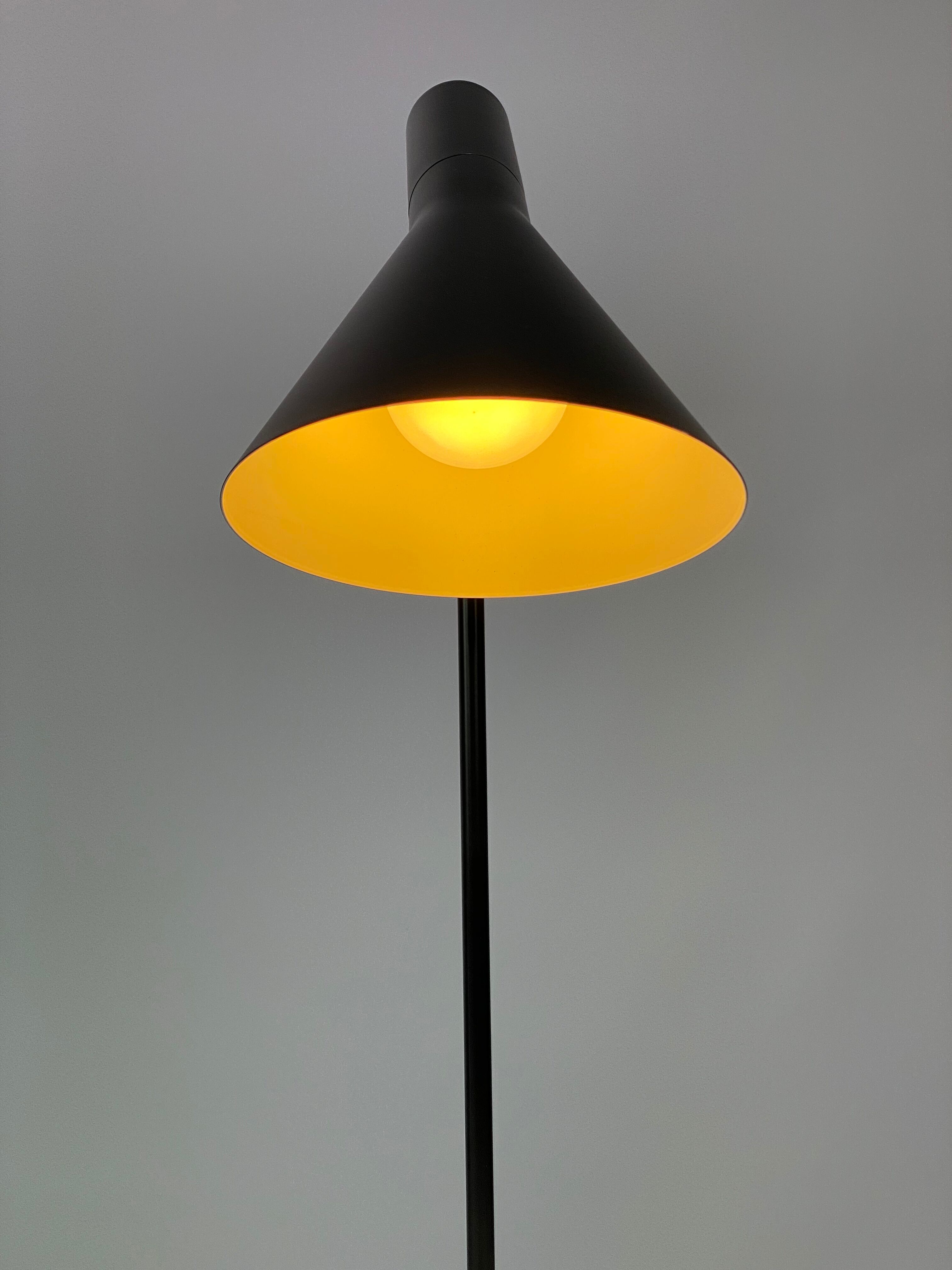 Black table lamp designed by Arne Jacobsen and manufactured by Louis Poulsen