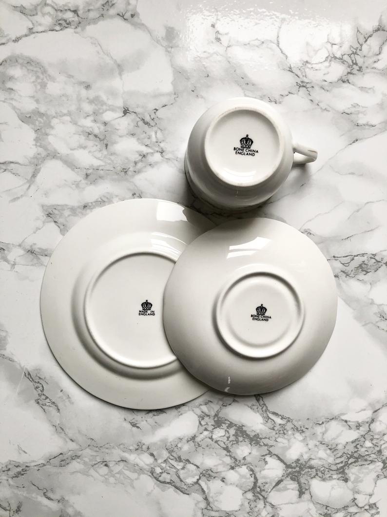 Teacup on its saucer and porcelain cake plate