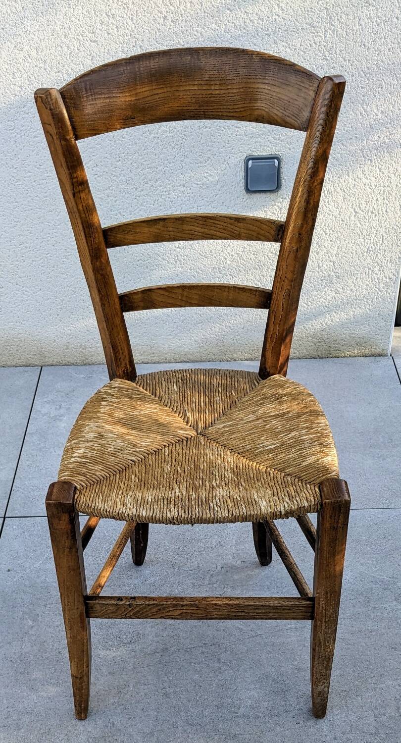 4 mismatched wood and straw chairs