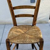 4 mismatched wood and straw chairs