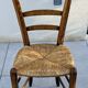 4 mismatched wood and straw chairs