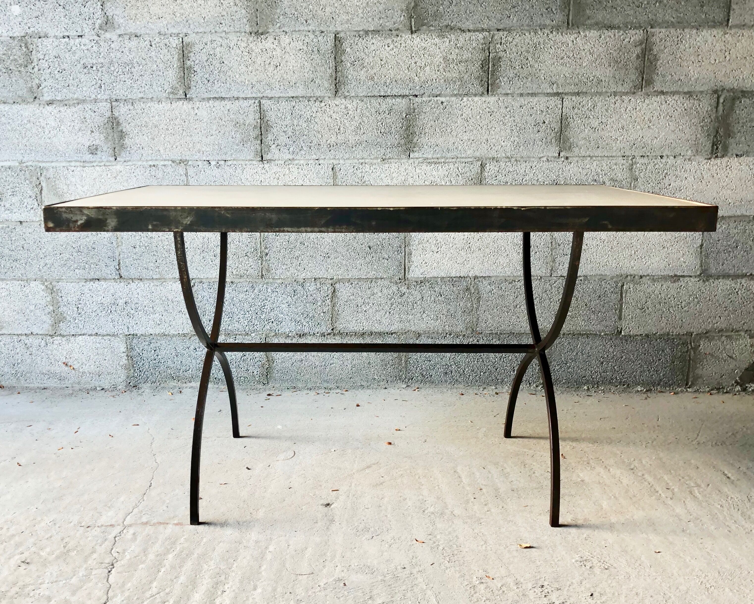 Table made of wrought iron and cement