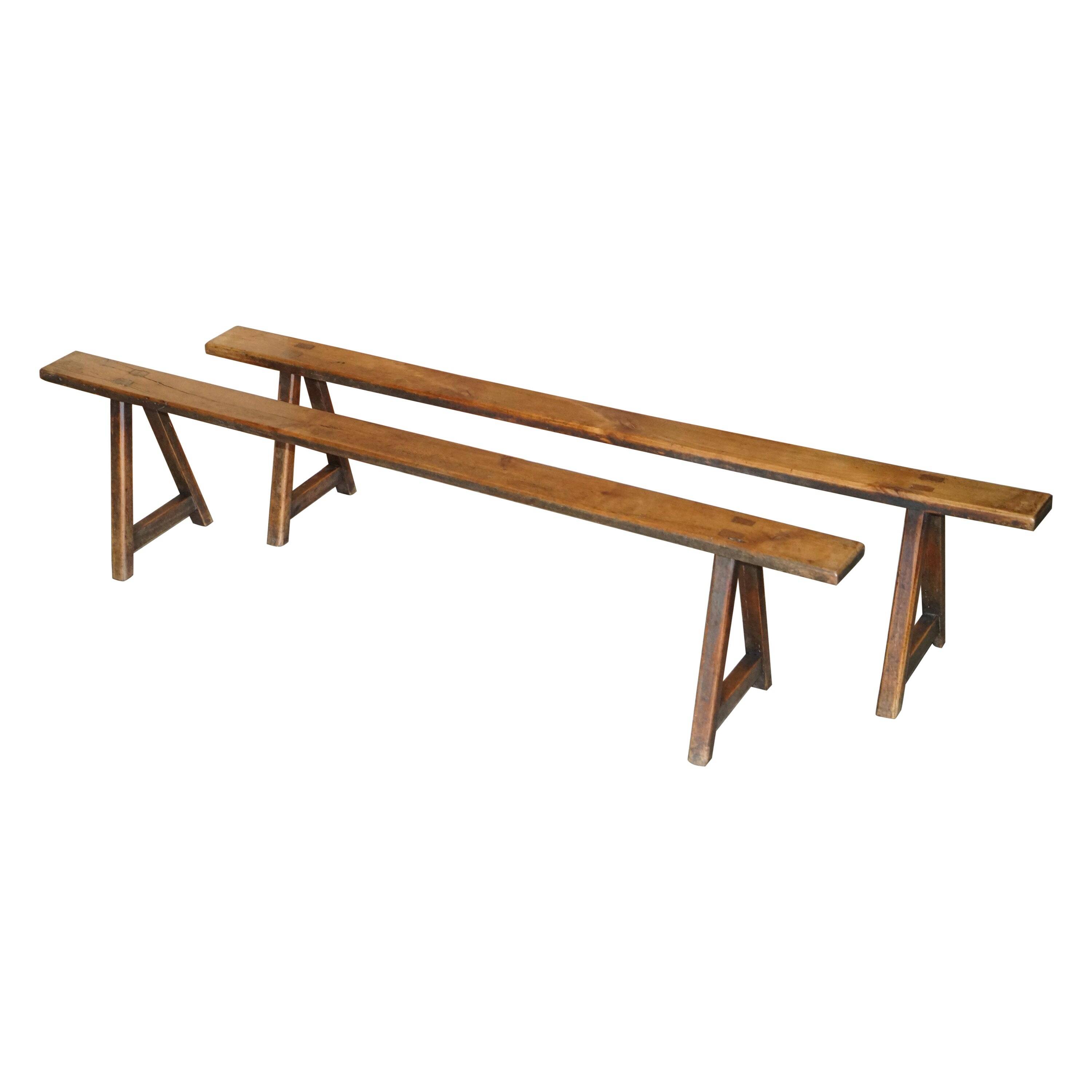 Pair of antique Victorian trestle benches in fruitwood.