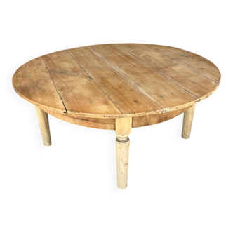 Round coffee table in raw wood