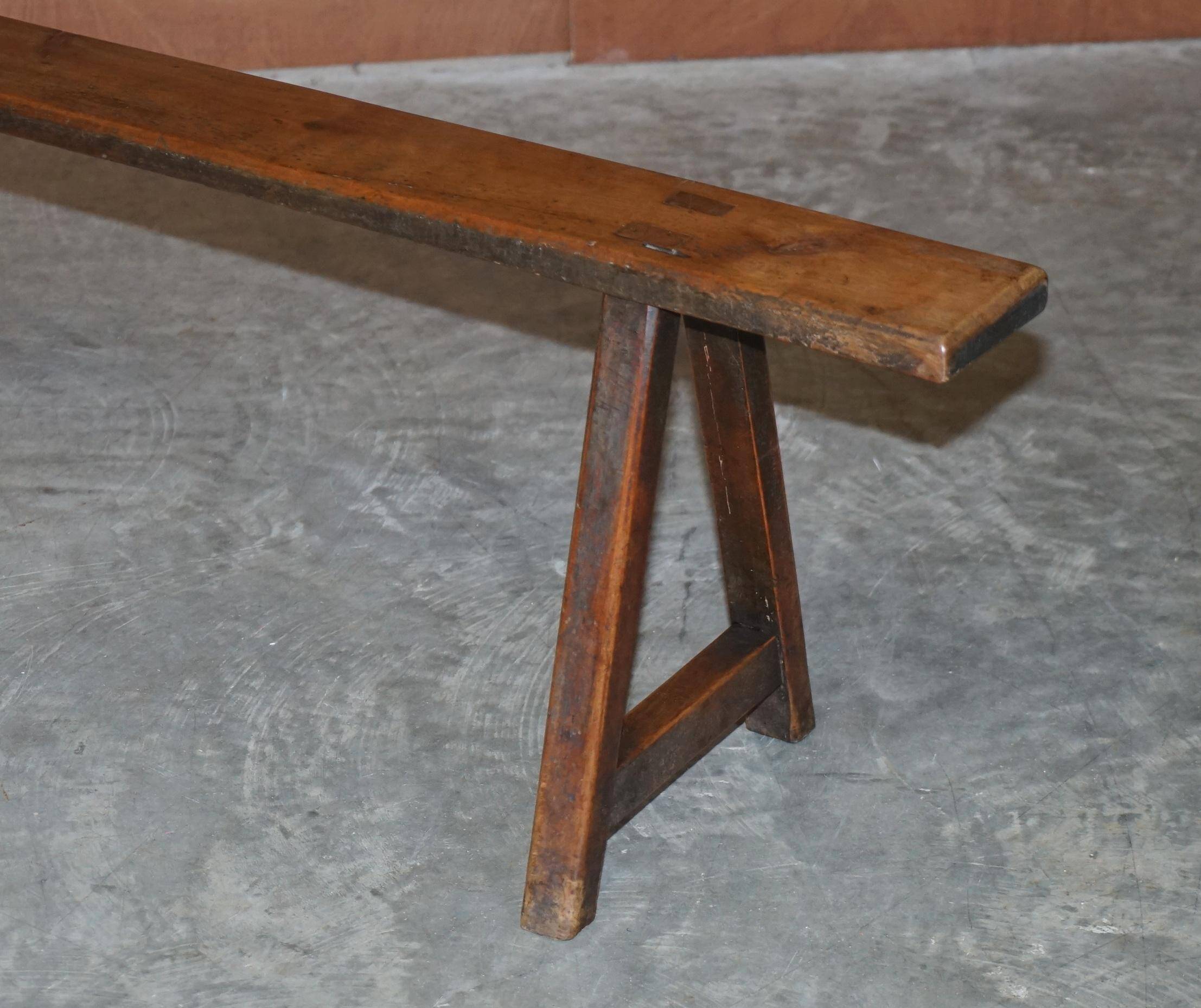 Pair of antique Victorian trestle benches in fruitwood.