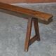 Pair of antique Victorian trestle benches in fruitwood.
