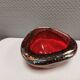 Small glass bowl in beautiful emerald red color with inlaid bubbles.