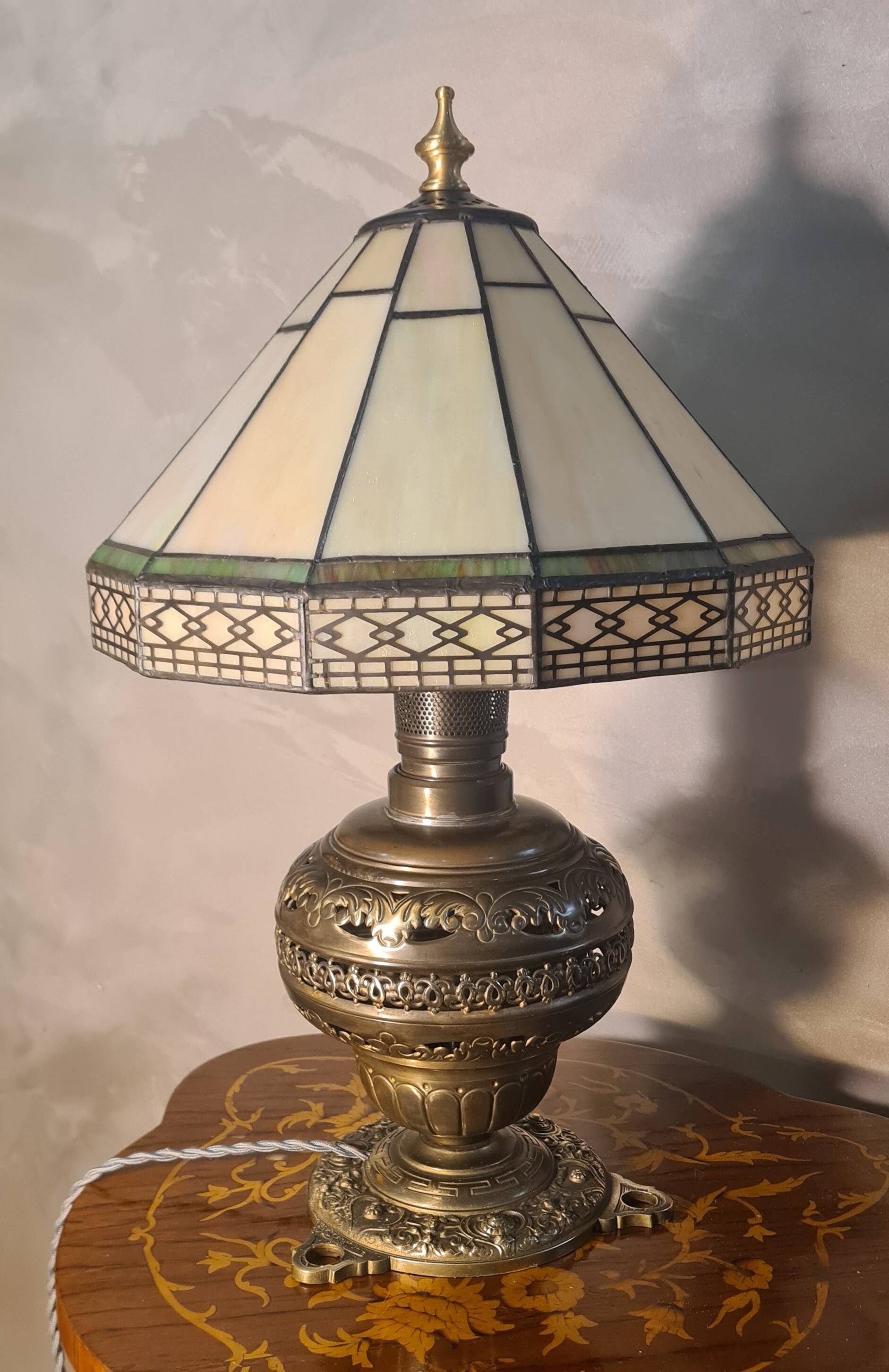 brass and bronze lamp with an antique base from 1900 and a glass paste shade