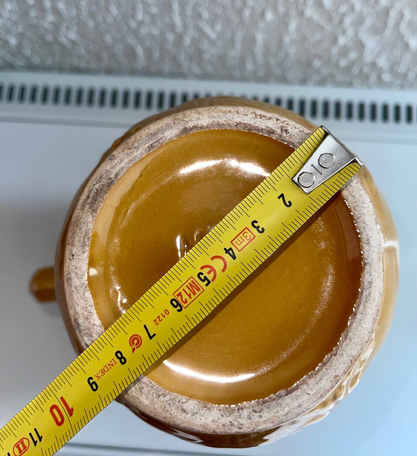 Antique pitcher with flower decoration