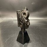 Ceramic sculpture representing a woman's face placed on a black base