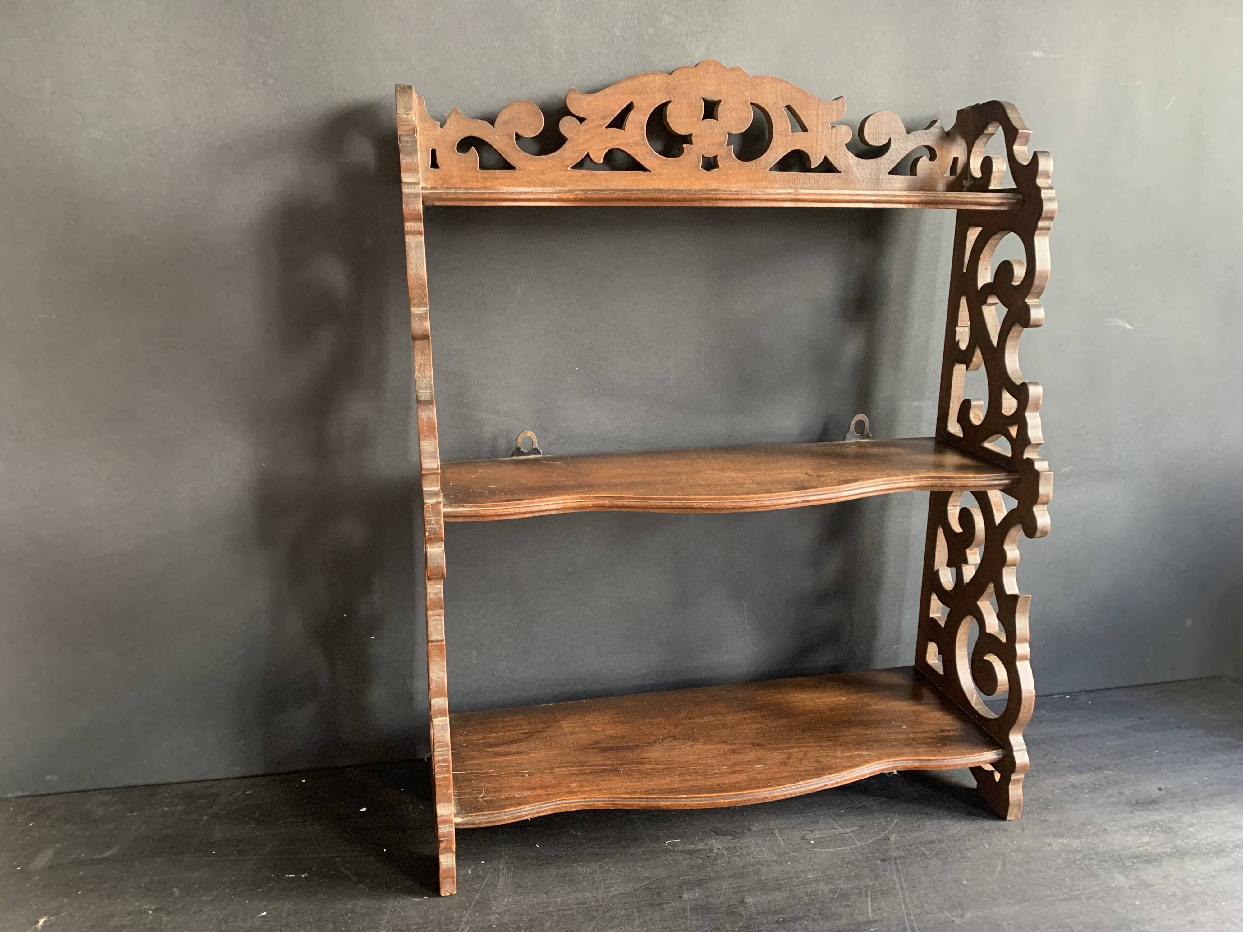 Antique shelf with openwork wooden pediment, early 20th century
