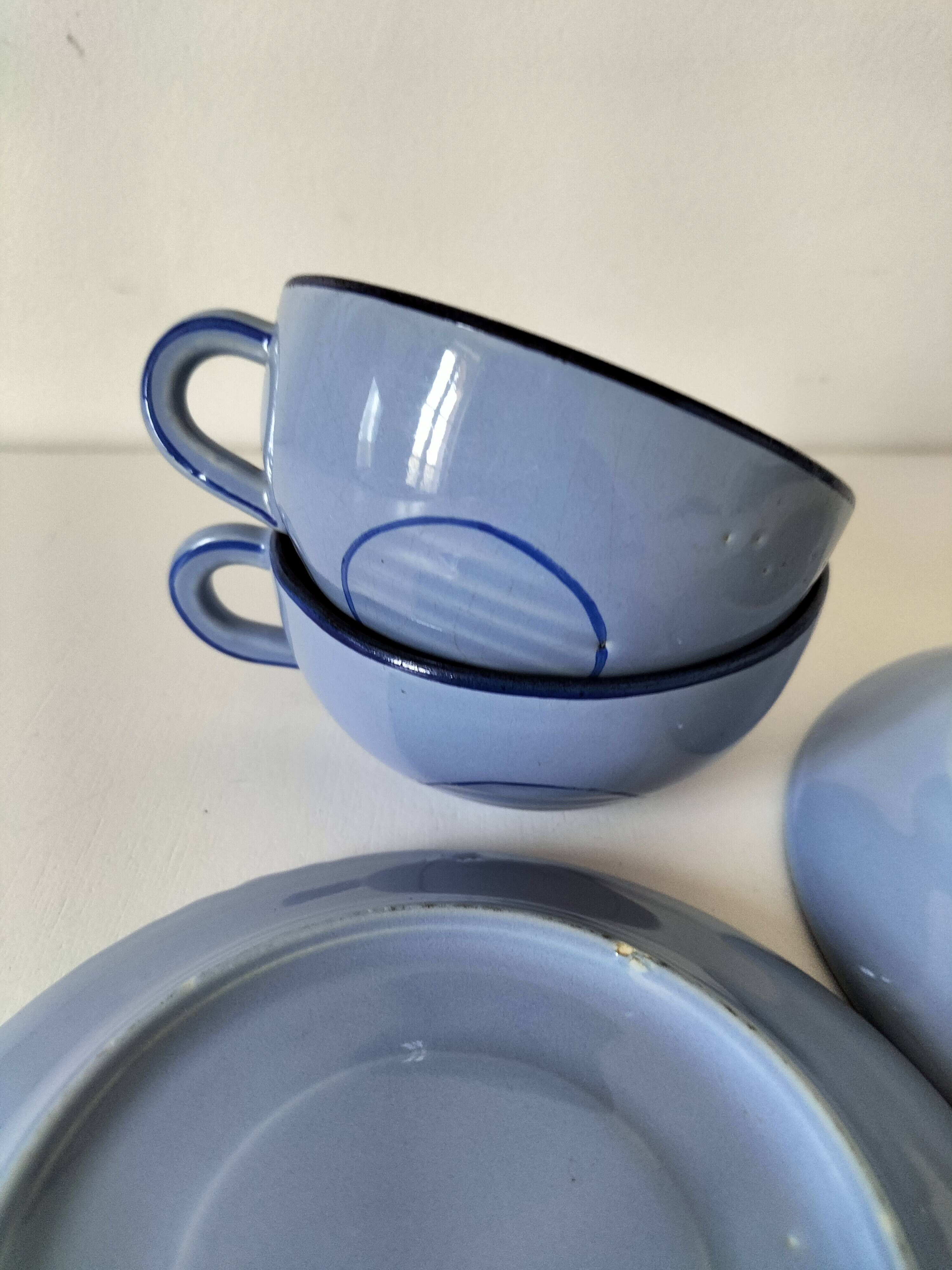 A pair of glazed ceramic cups and saucers from the 60s-70s.