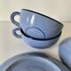 A pair of glazed ceramic cups and saucers from the 60s-70s.