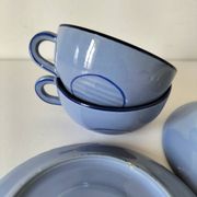 A pair of glazed ceramic cups and saucers from the 60s-70s.