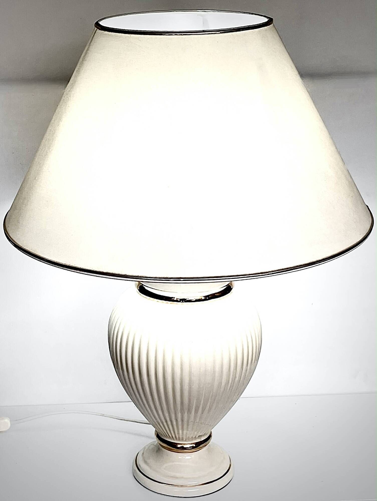 Vintage white ceramic table lamp, ribbed body and conical shade.